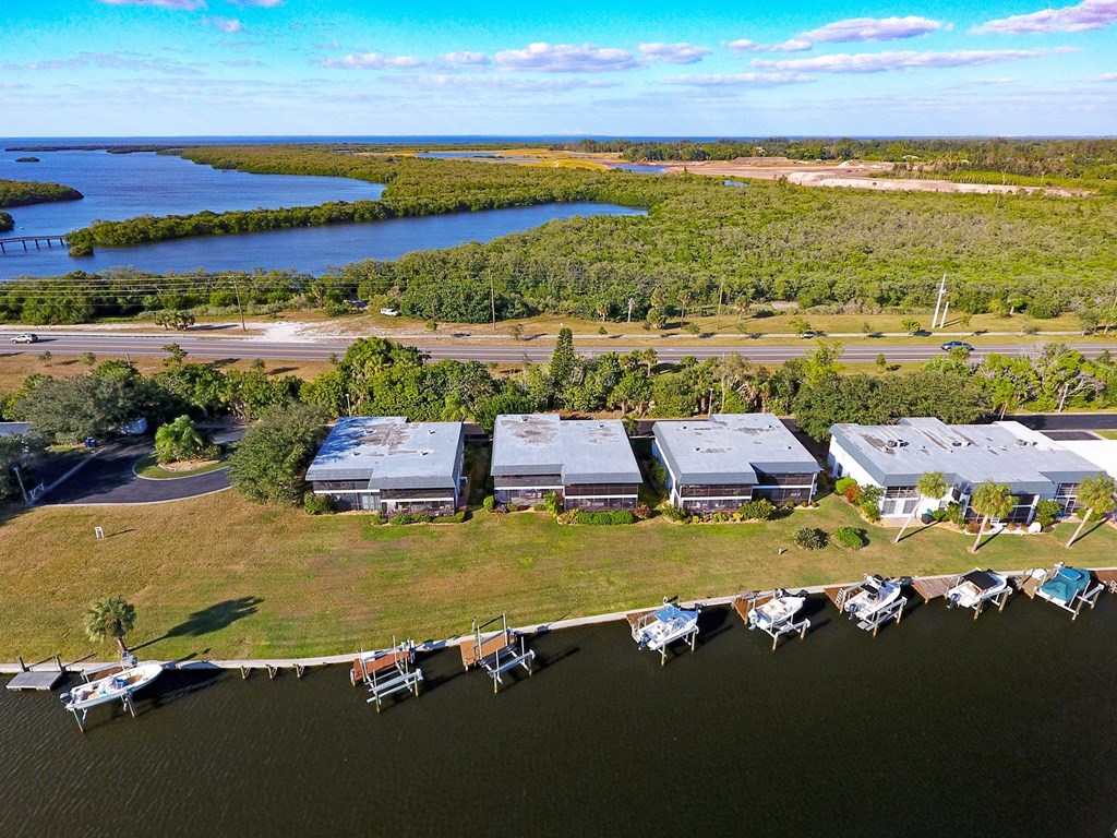 an aerial view of a marina with boats docked on the water and buildings