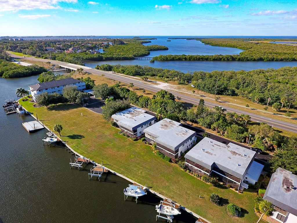 an aerial view of a marina with boats on the water and a highway