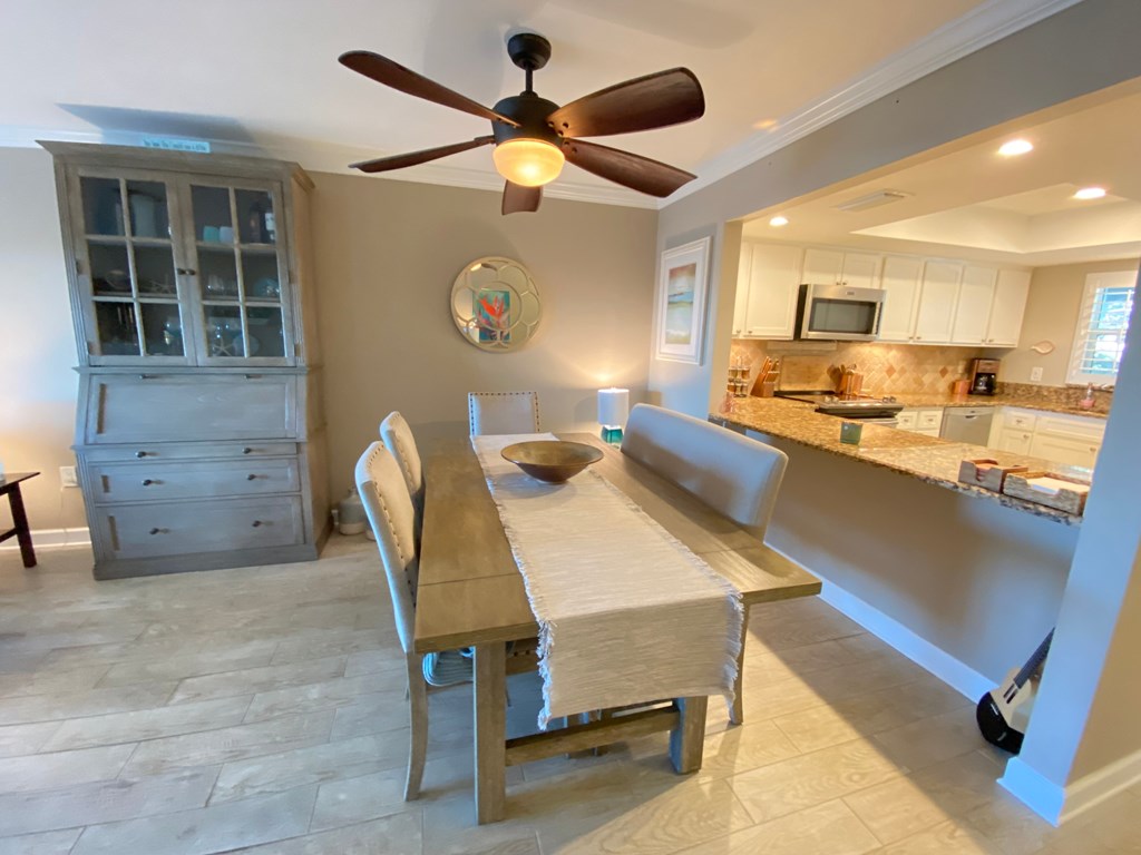 another view of the dining room with the kitchen in the background