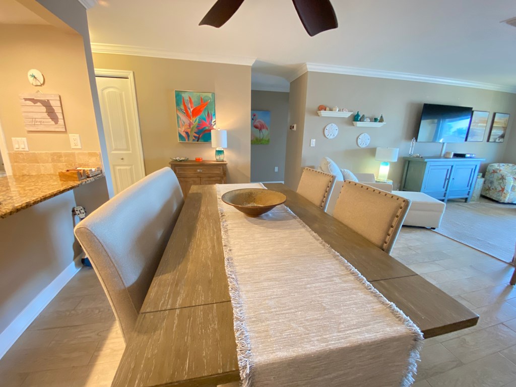 a view of the dining room with the living room and kitchen in the background