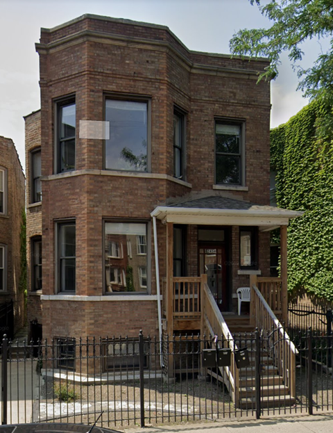 a brick building with a porch and a