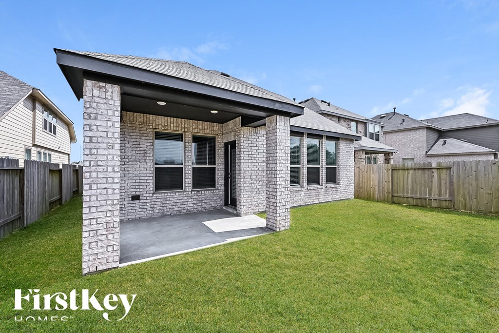 A house with a covered patio is for sale by FirstKey Homes.