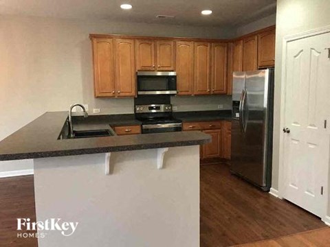 a kitchen with a counter top and a refrigerator