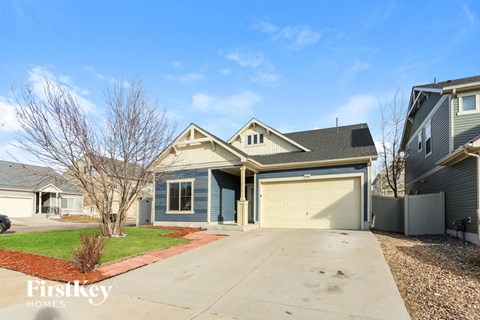 A house with a blue garage door is for sale.