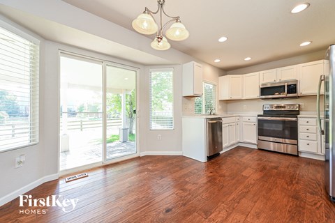 an empty kitchen with a door to a patio