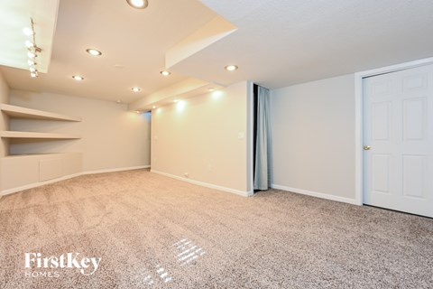 a bonus room with a closet and a white door