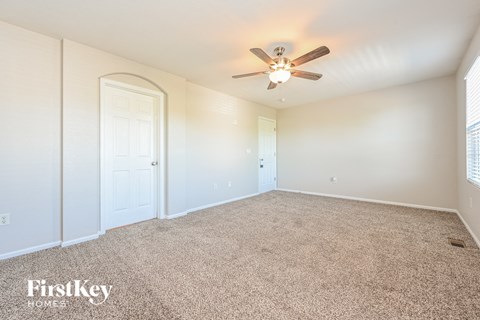 an empty room with a ceiling fan and a closet