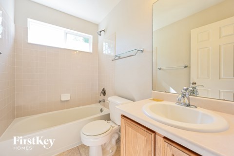 a bathroom with a sink toilet and a bath tub