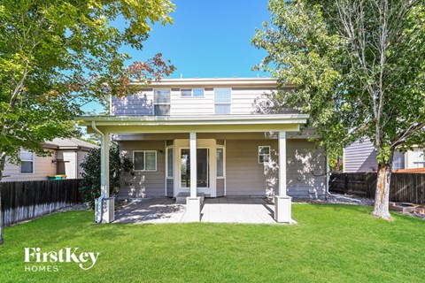 a white house with a lawn and a porch