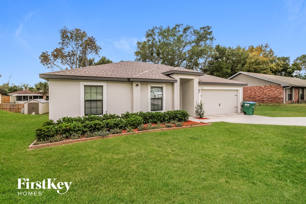 a home with a lawn and a driveway