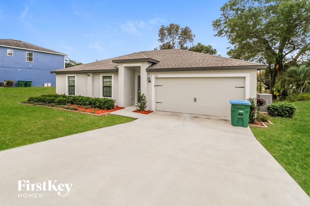a white house with a driveway and a garage door
