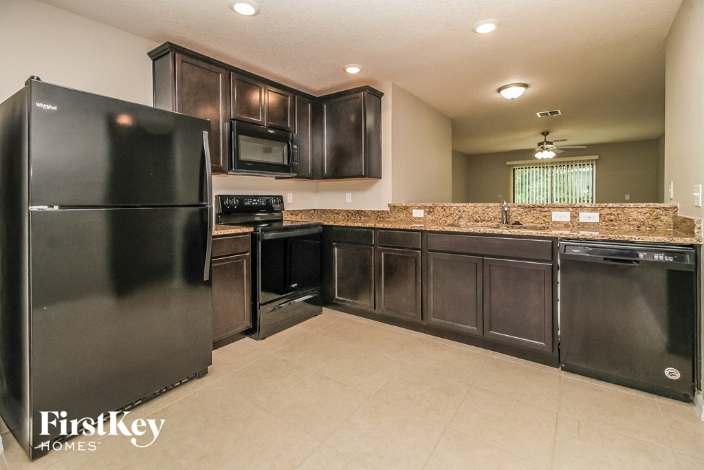 a kitchen with stainless steel appliances and granite counter tops