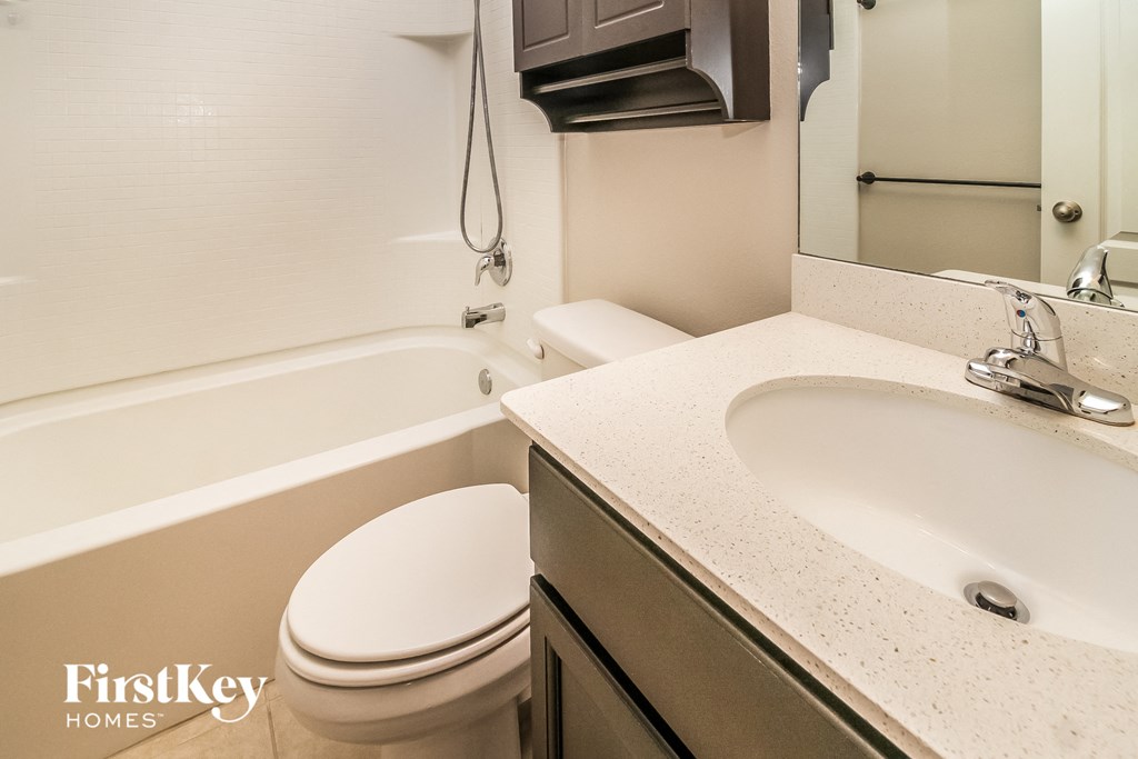 a bathroom with a sink toilet and a bath tub