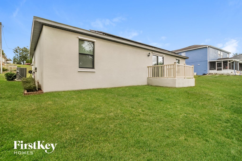 a white house with a yard and a porch