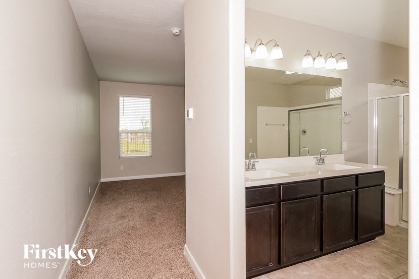 a bathroom with a large mirror and a sink and a mirror