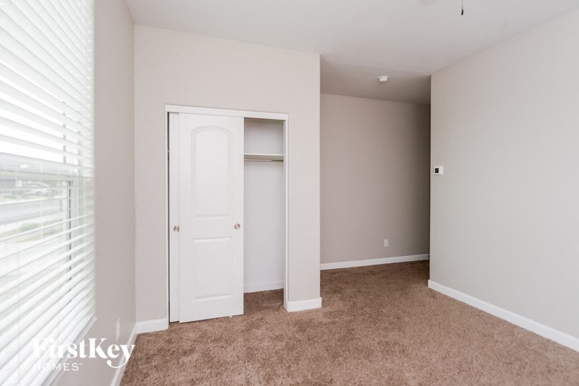 a bedroom with a closet and a window