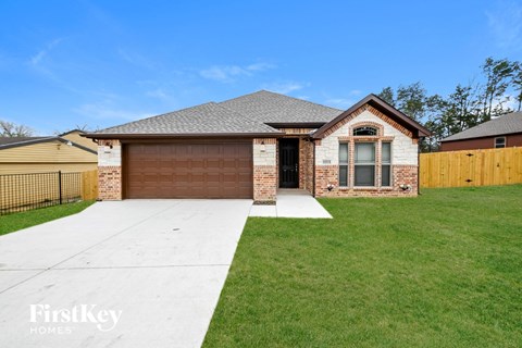 a brick house with a garage and a driveway