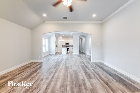 the living room is open to the kitchen and dining room