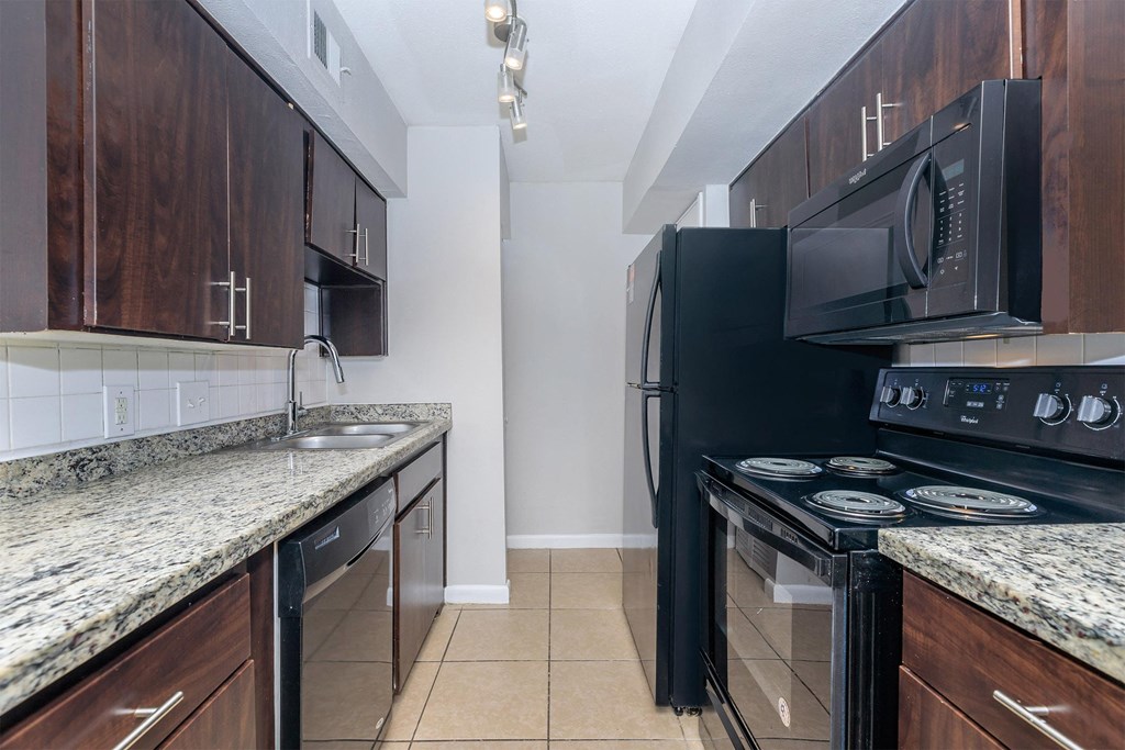 a kitchen with black appliances and granite counter tops and