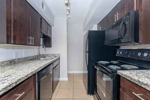 a kitchen with black appliances and granite counter tops and