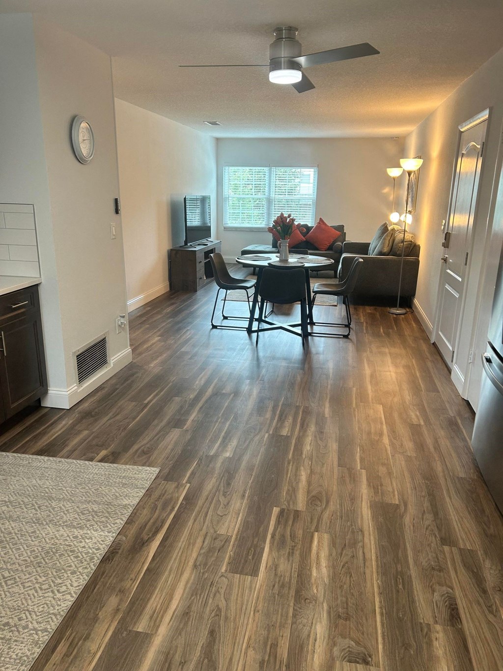 an open living room and dining room with hardwood floors