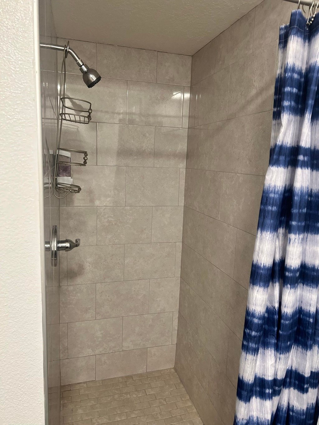 a bathroom with a shower and a curtain