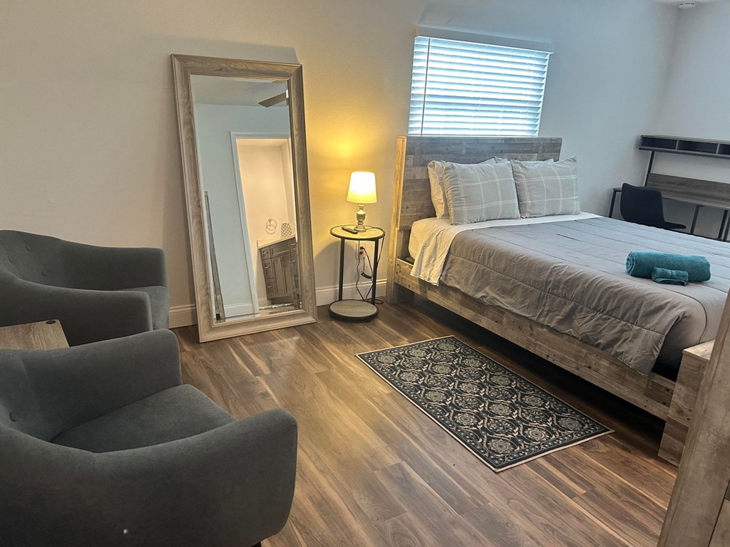 a bedroom with a large mirror and a bed