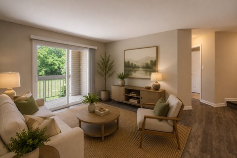 A living room with a white couch, a coffee table, and a painting on the wall.