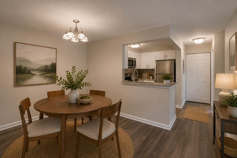A dining room with a round table and chairs.