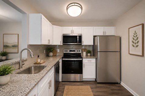 A modern kitchen with stainless steel appliances and white cabinets.