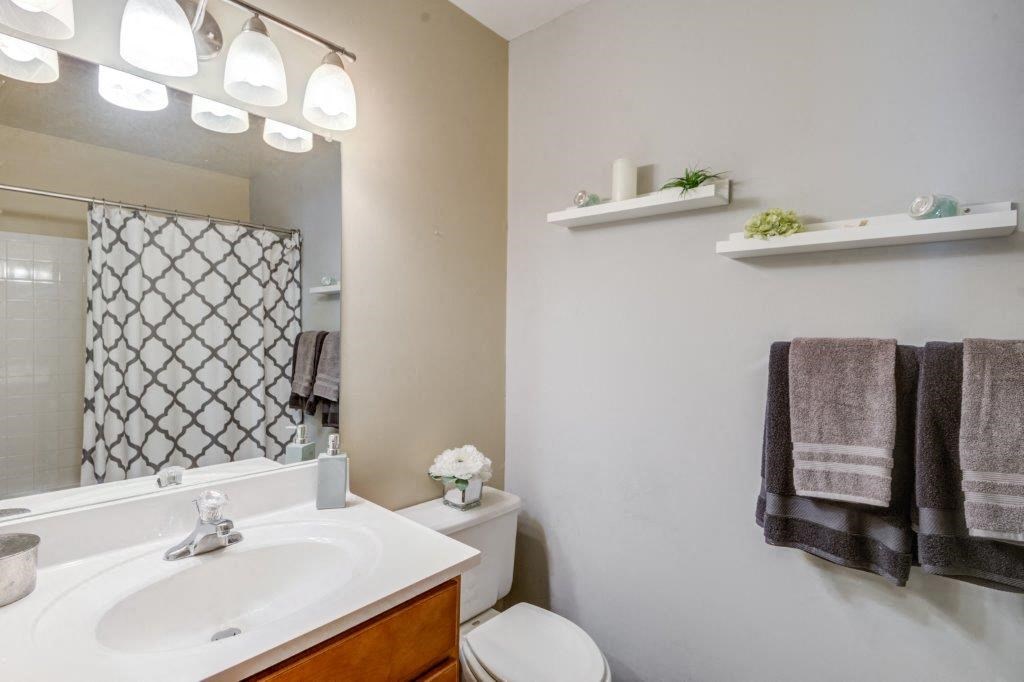 a bathroom with a sink toilet and a mirror