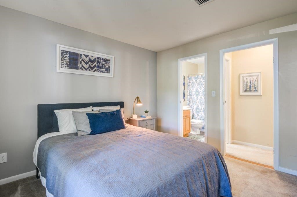 a bedroom with a bed and a door to a bathroom