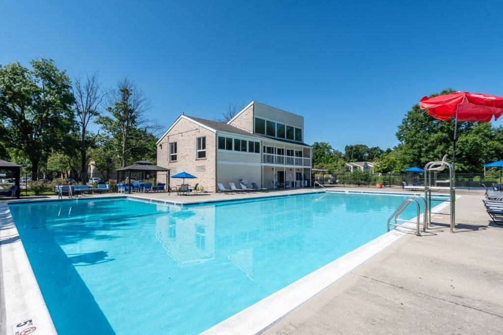 a swimming pool with a building in the background
