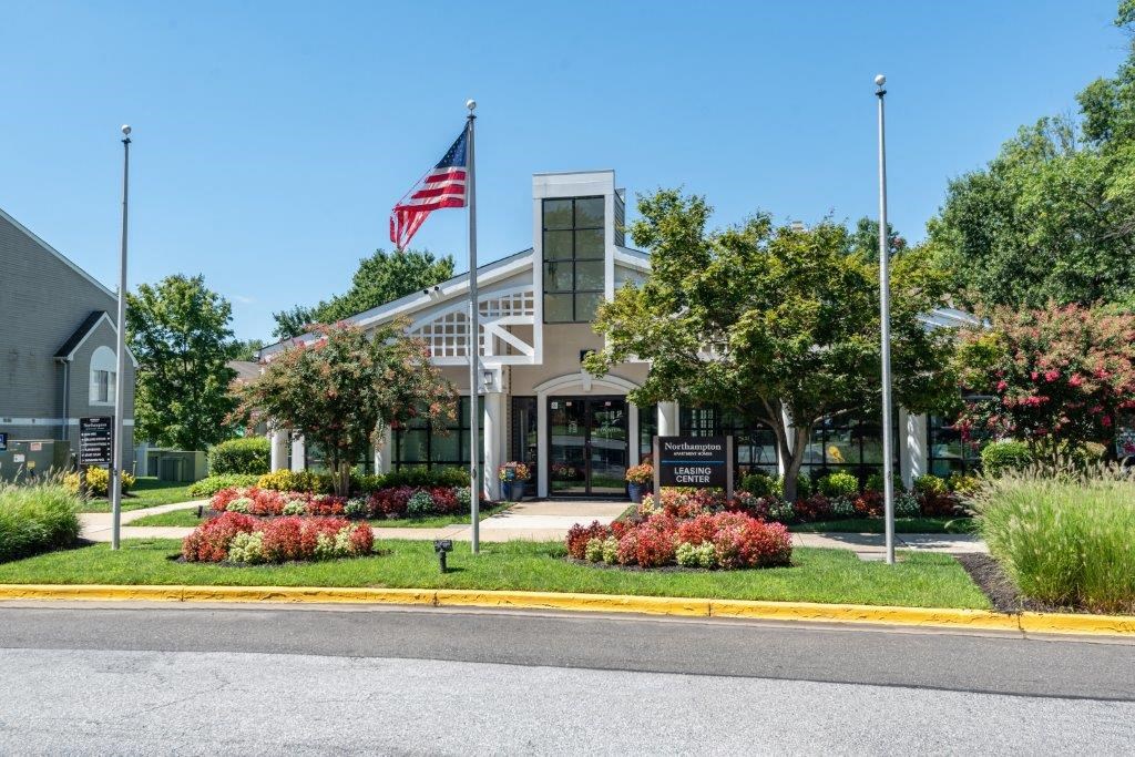 the front of a building with an flag in front of it