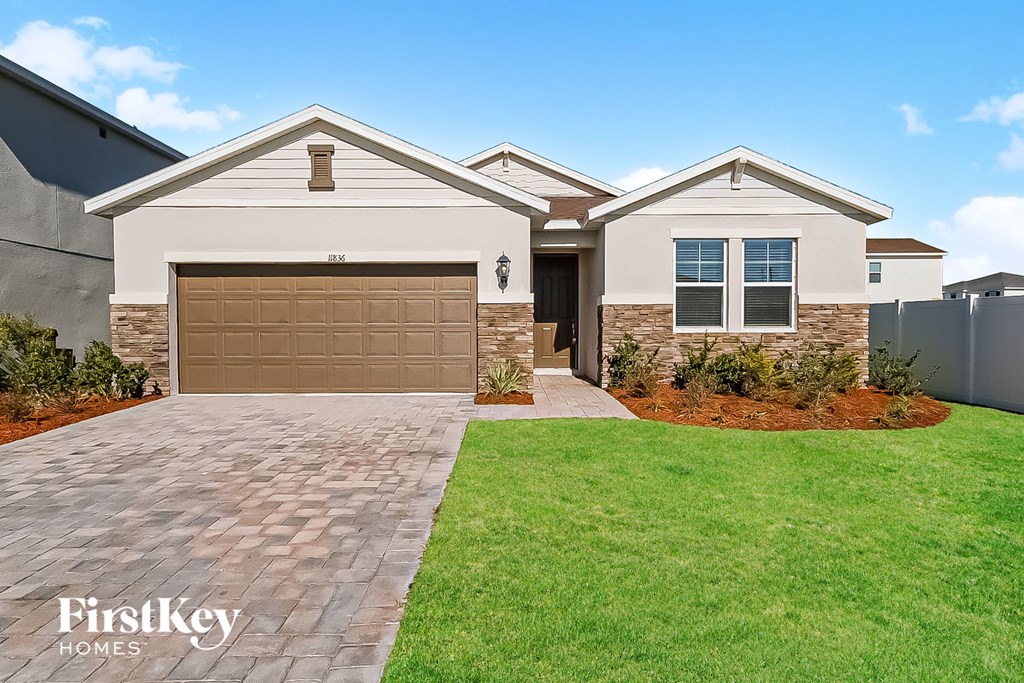 a new home with a garage door in front of it