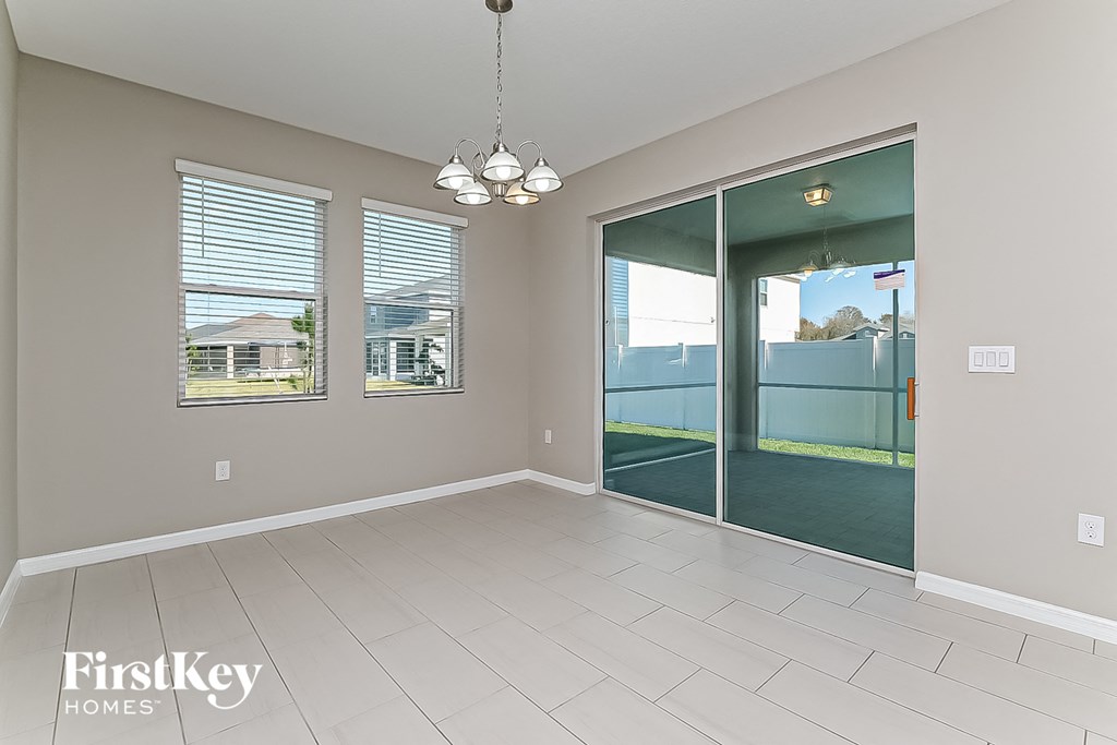 a spacious living room with a sliding glass door to the patio