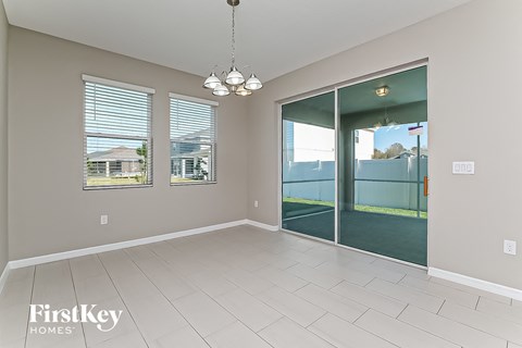 a spacious living room with a sliding glass door to the patio