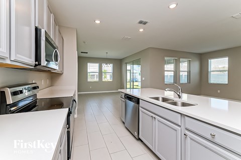 a kitchen with white counter tops and a sink