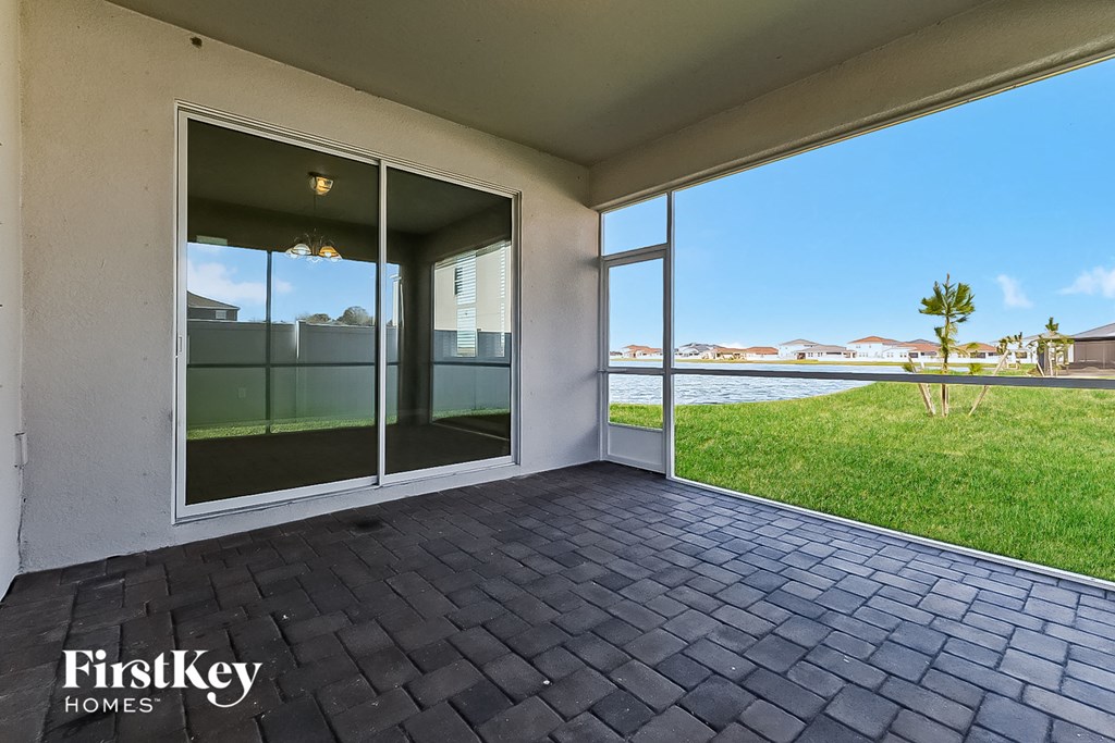 a patio with a view of a body of water
