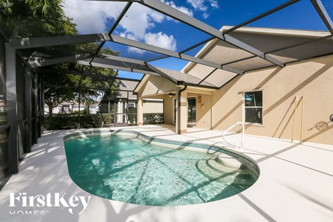 a patio with a pool and a house