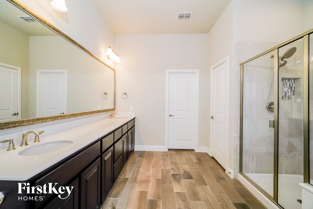 a master bathroom with a large mirror and a shower