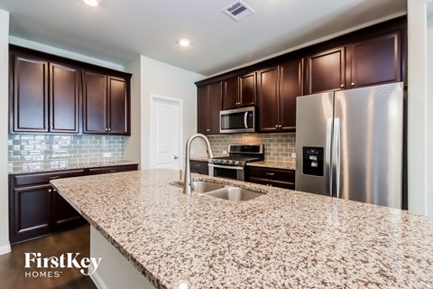 a kitchen with granite counter tops and stainless steel appliances