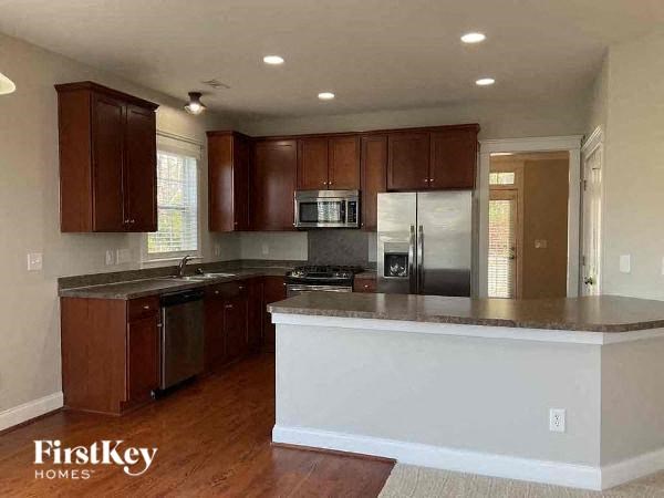 A kitchen with wooden cabinets and a refrigerator.