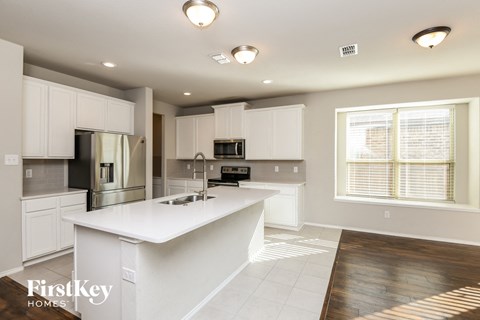 a large kitchen with white cabinets and a white counter top