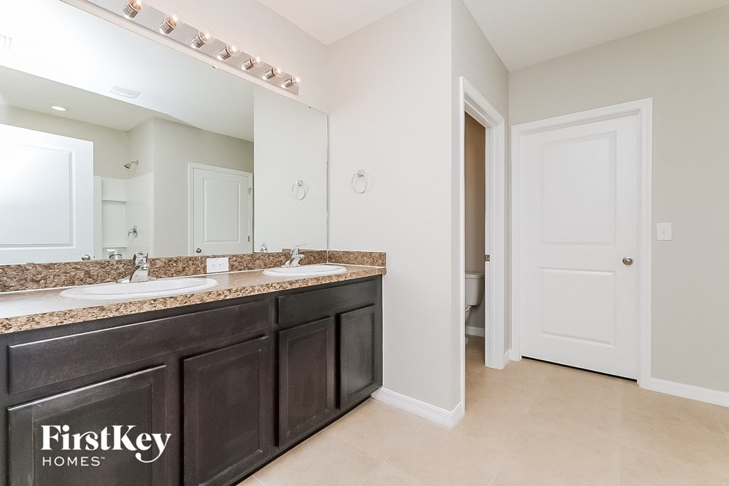 a bathroom with two sinks and a large mirror