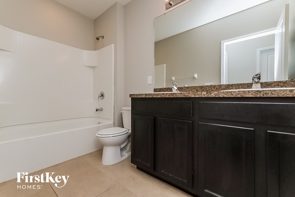 a bathroom with a toilet and a sink and a bath tub