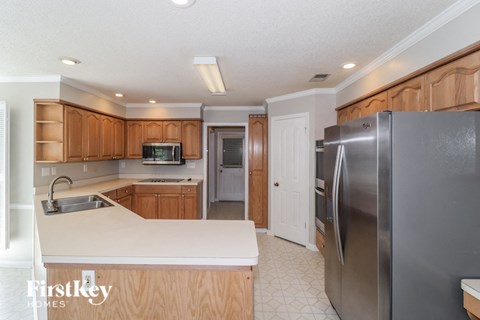 a kitchen with stainless steel appliances and wooden cabinets