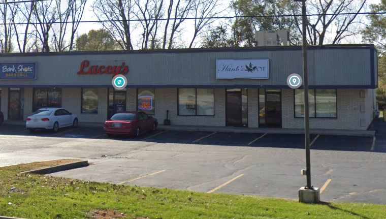 a parking lot in front of a store with cars parked