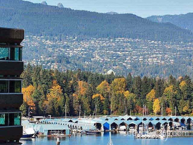 A bridge over a body of water with boats docked underneath it.