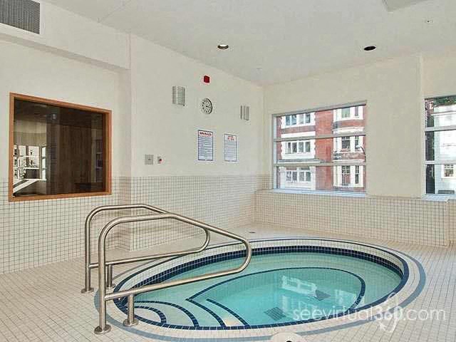 A small indoor pool with a metal railing.